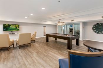 A conference room with a large table and chairs.